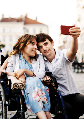 man taking selfie with sister in wheelchair