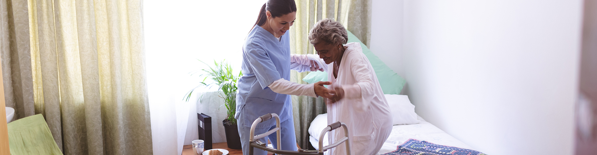 caretaker helps elder lady stand up